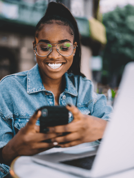 Woman using phone smiling