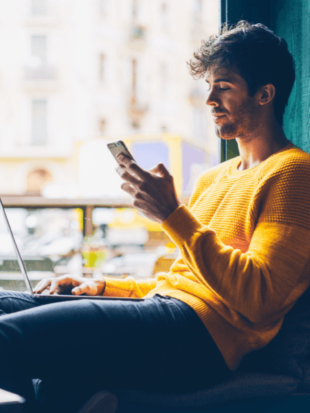 Man in yellow using laptop